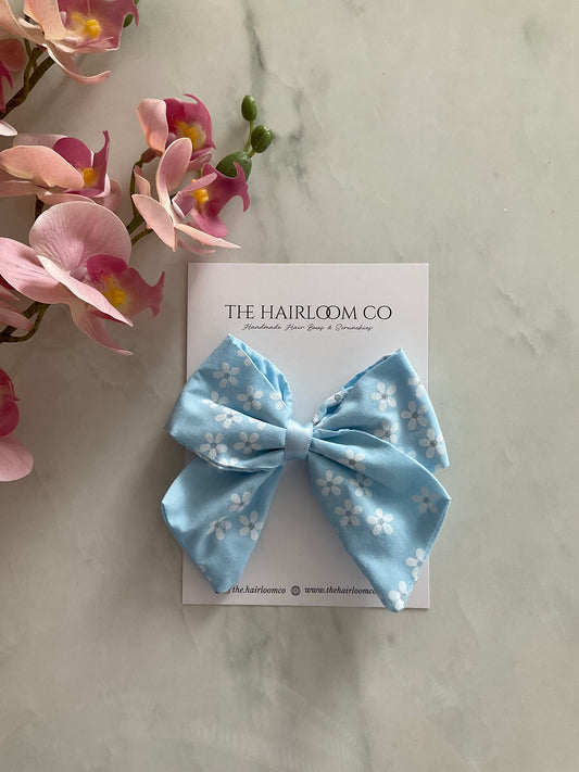 Blue daisy sailor hair bow in sky blue cotton with white daisy print and alligator clip — handmade by The Hairloom Co. Canberra Australia