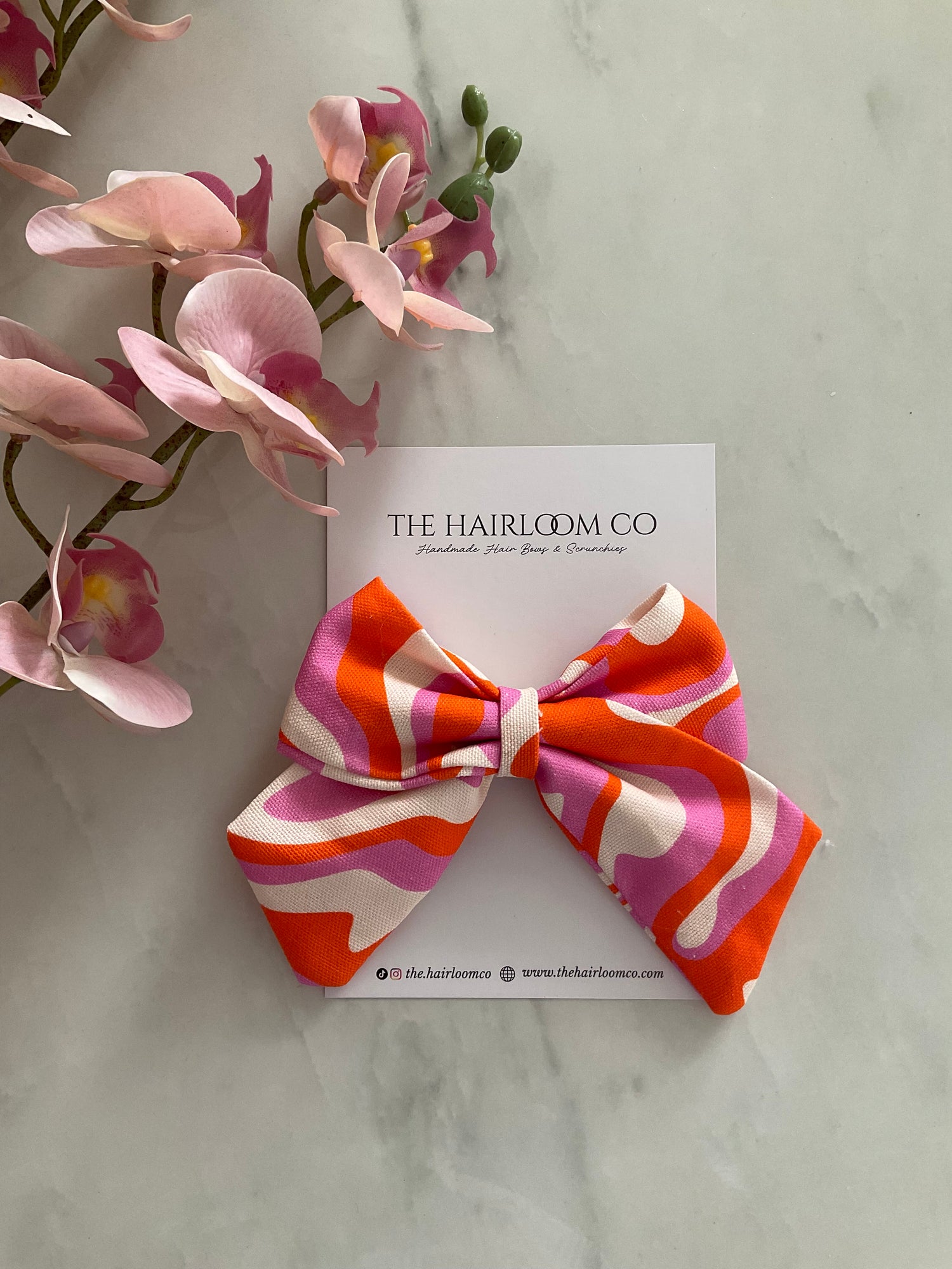 Sorbet swirl sailor hair bow in pink orange and cream print with alligator clip — handmade by The Hairloom Co. Canberra Australia