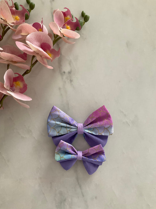 Mermaid petal hair bow in iridescent purple and blue mermaid scale print with purple accent fabric — handmade by The Hairloom Co. Canberra Australia