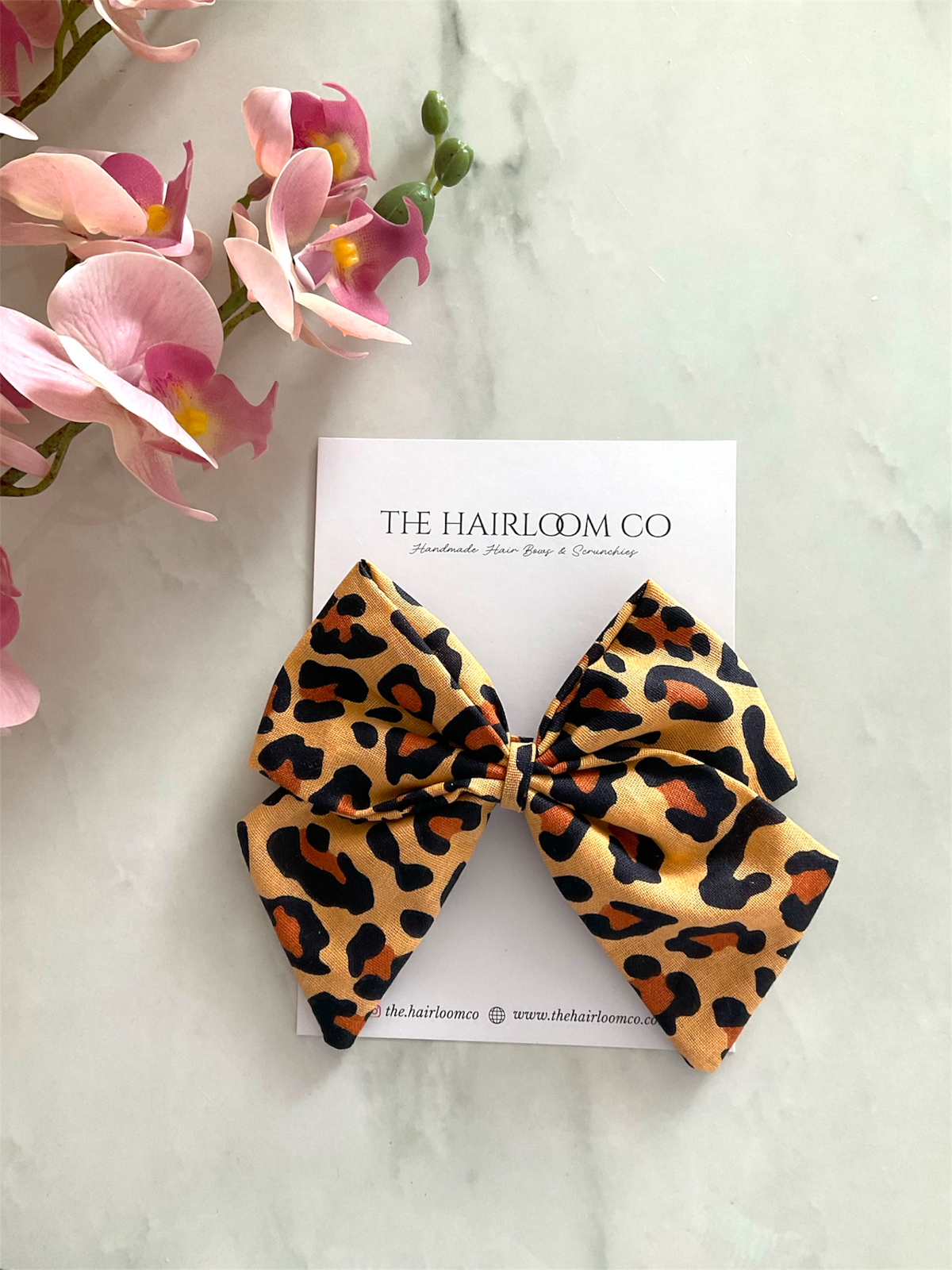 Savannah golden leopard print sailor hair bow in tan orange and black cotton with alligator clip — handmade by The Hairloom Co. Canberra Australia