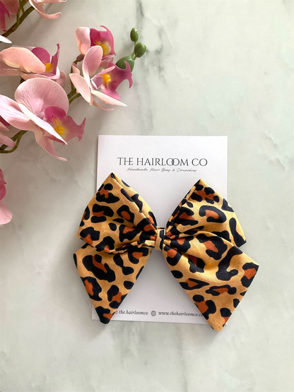 Savannah golden leopard print sailor hair bow in tan orange and black cotton with alligator clip — handmade by The Hairloom Co. Canberra Australia